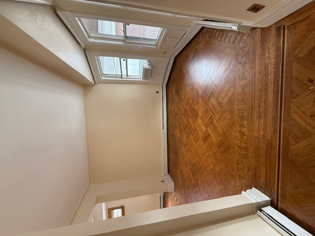 1587 East 18th Street, Unit 2 Brooklyn, NY 11230 - Photo 4 of 13 wooden floor in an empty room with a window