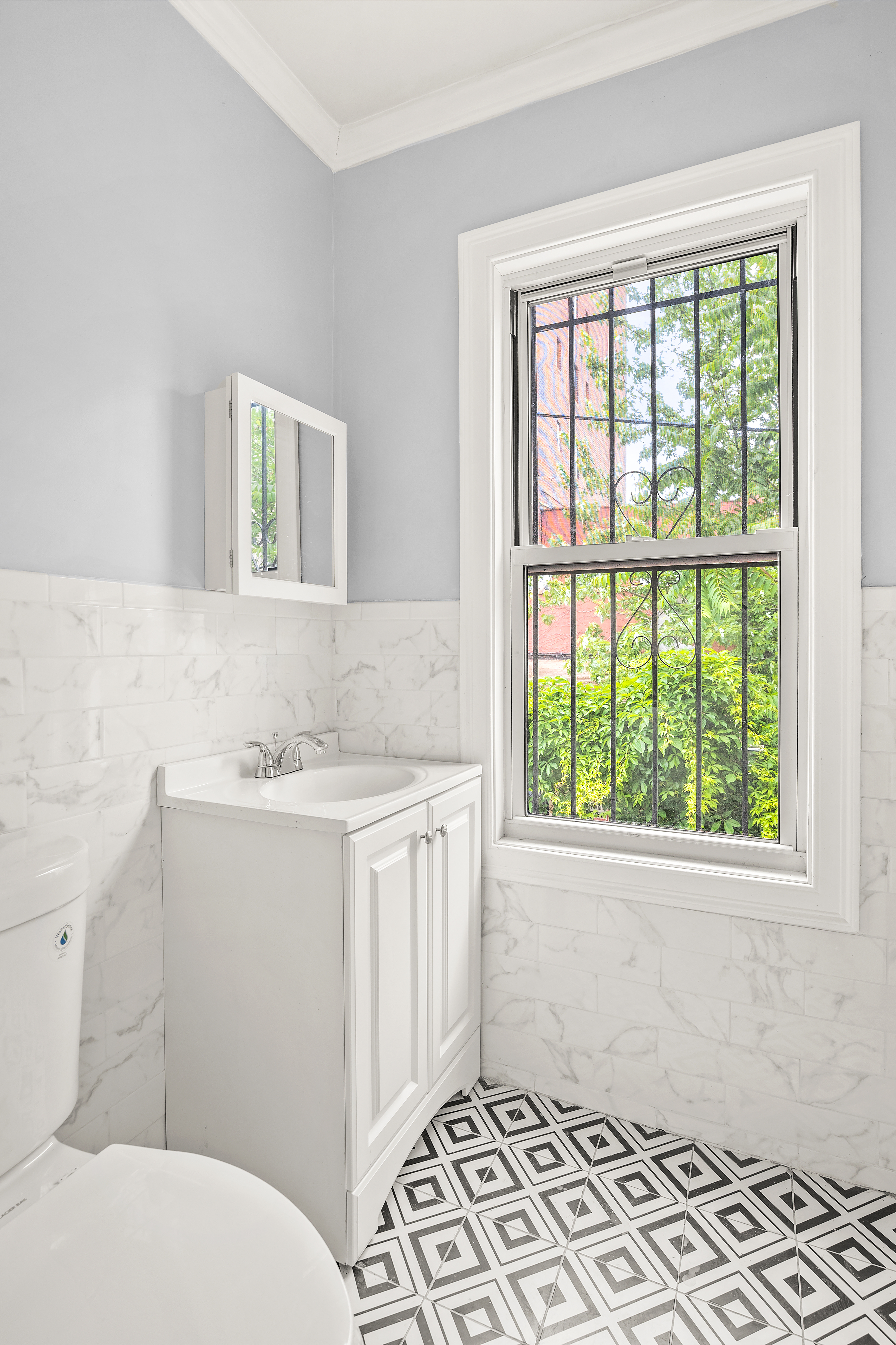 806 East 48th Street Brooklyn, NY 11203 - Photo 11 of 13 a bathroom with a sink toilet and window