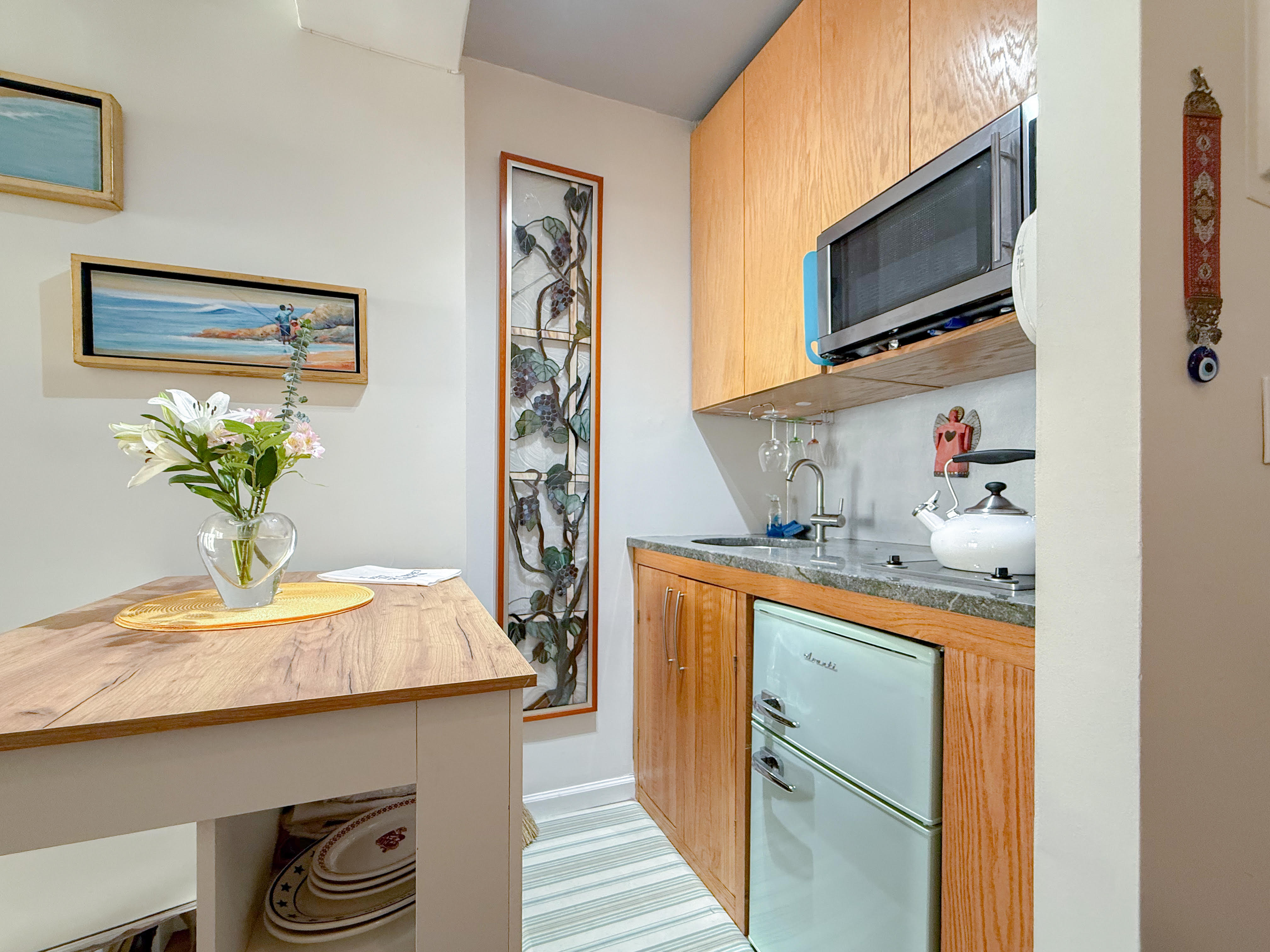 230 Central Park West, Unit 14I Manhattan, NY 10024 - Photo 7 of 17 a kitchen with stainless steel appliances kitchen island granite countertop a sink a stove and a wooden floors