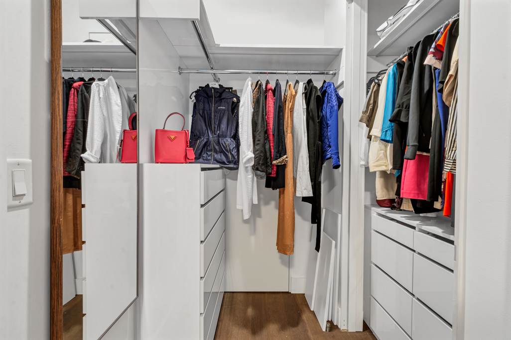 25 Broad Street, Unit 11K Manhattan, NY 10004 - Photo 6 of 16 a view of walk in closet with clothes