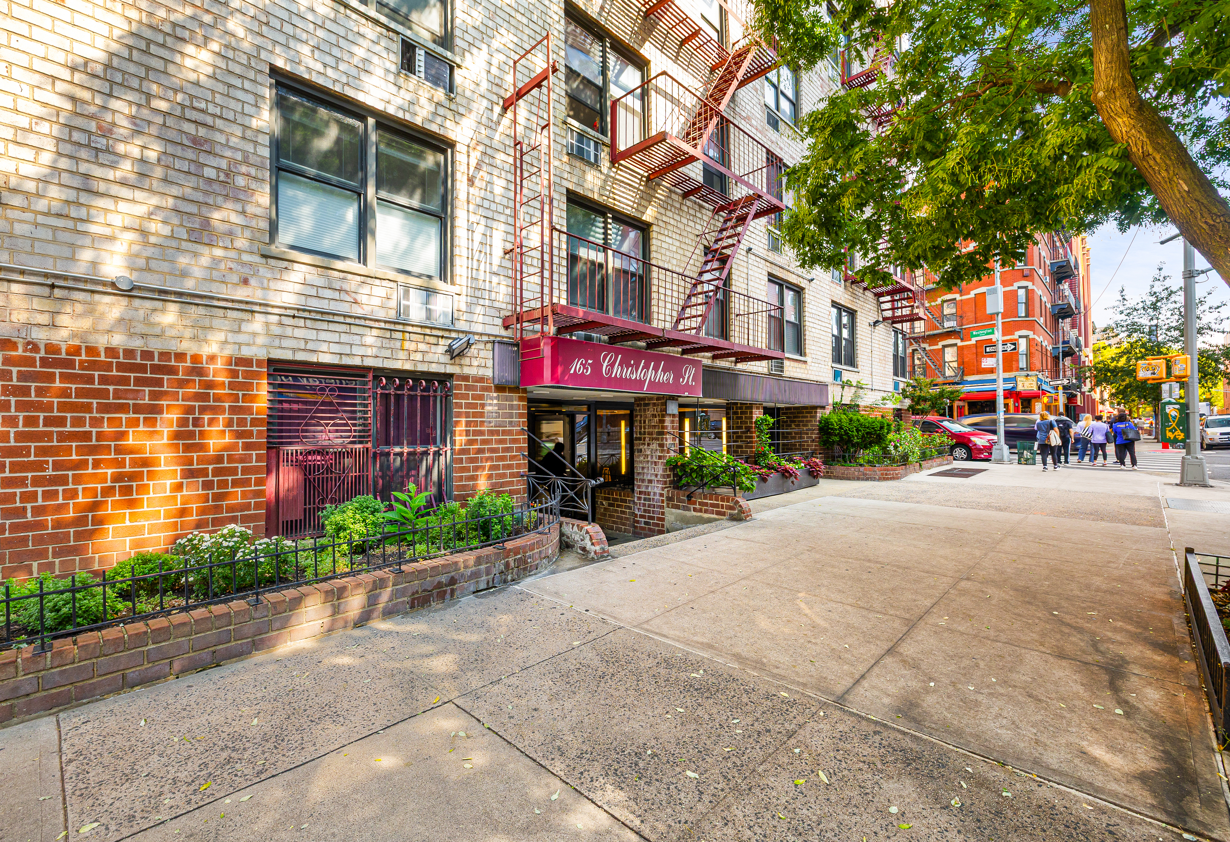 165 Christopher Street, Unit 5DD Manhattan, NY 10014 - Photo 13 of 15 a view of street with a building and trees in the background
