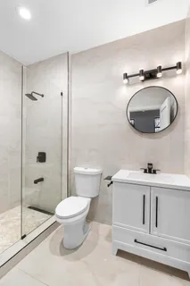 a bathroom with a toilet a sink and shower