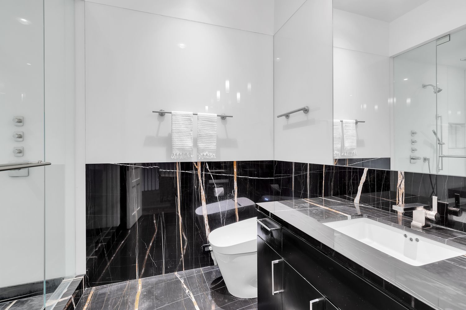 42 West 71st Street Manhattan, NY 10023 - Photo 19 of 35 a bathroom with a sink a toilet a mirror and shower