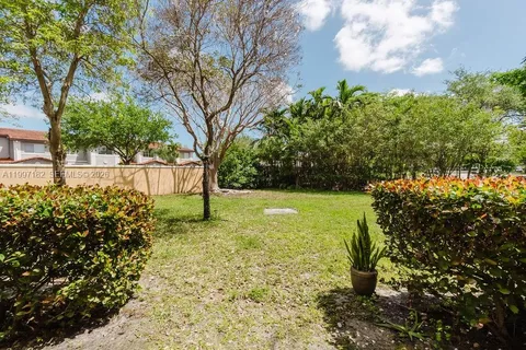 a big yard with lots of green space and plants