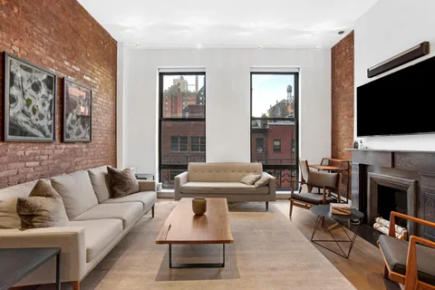 a living room with furniture fireplace and a flat screen tv