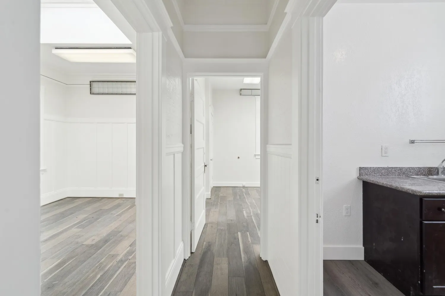 a view of a room with wooden floors and led lights