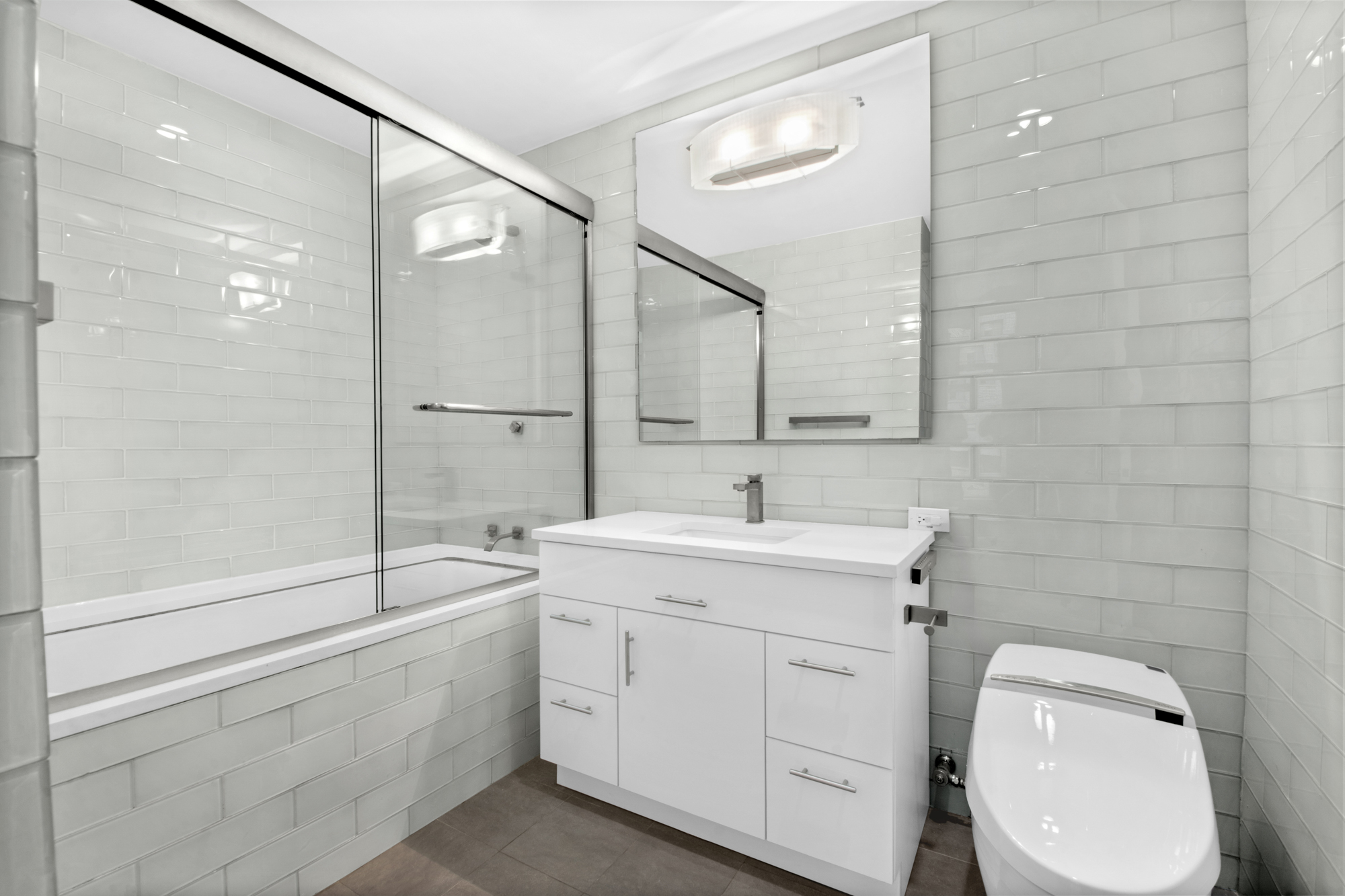 5 East 44th Street, Unit 5A Manhattan, NY 10017 - Photo 5 of 15 a bathroom with a toilet sink and mirror