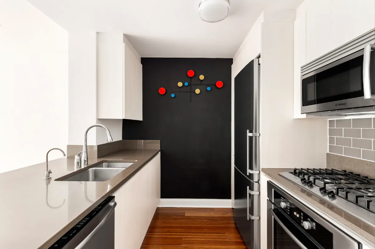 57 Reade Street, Unit 5B Manhattan, NY 10007 - Photo 2 of 5 a kitchen with granite countertop a stove and a sink