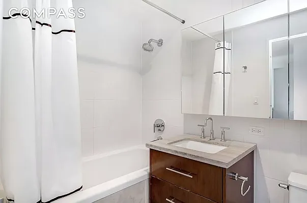 125 North 5th Street, Unit 3D Brooklyn, NY 11249 - Photo 5 of 10 a bathroom with a granite countertop sink toilet and shower