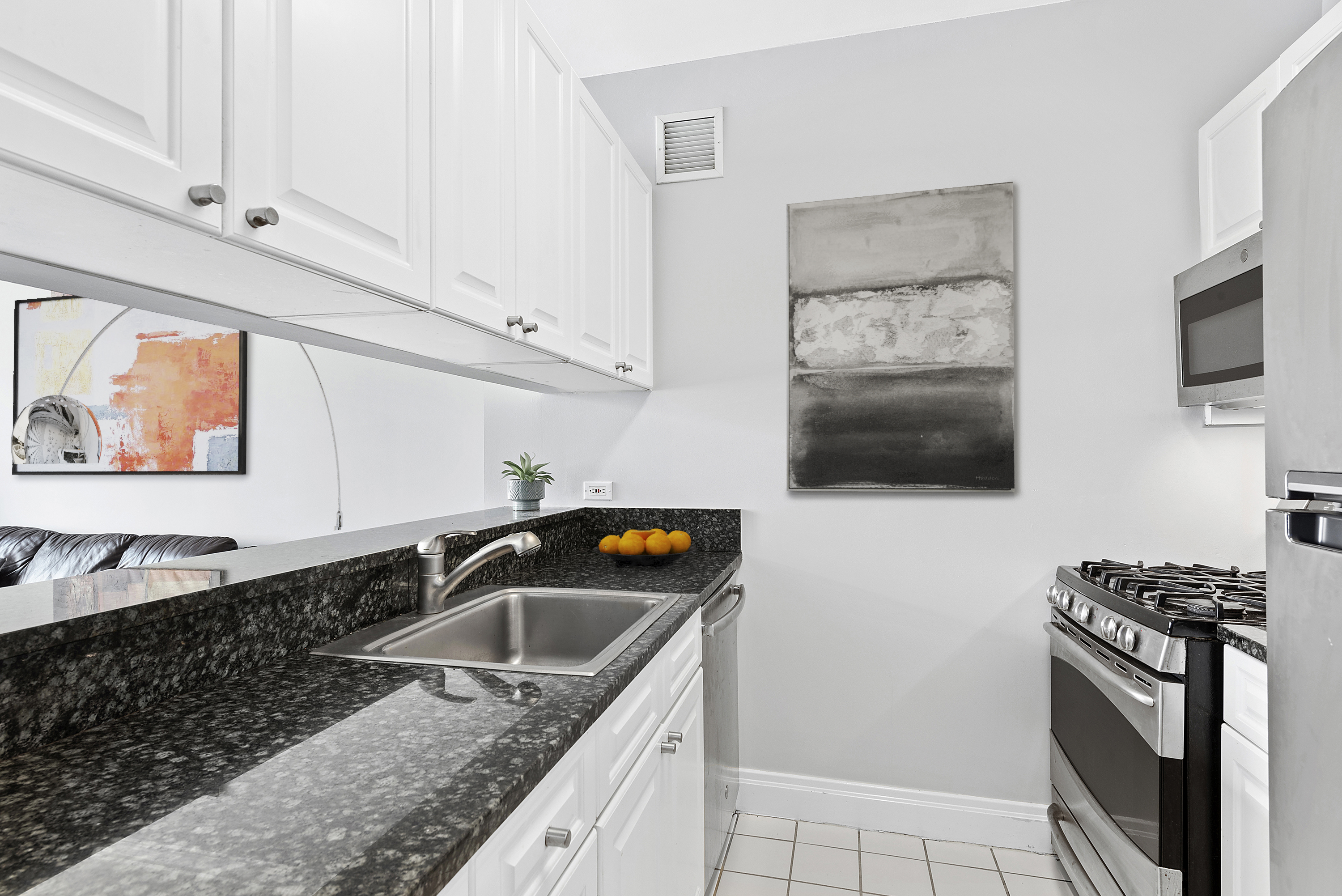 400 East 90th Street, Unit 8E Manhattan, NY 10128 - Photo 3 of 6 a kitchen that has a sink and a stove