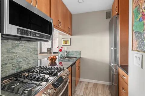 a kitchen with stainless steel appliances a stove and a microwave