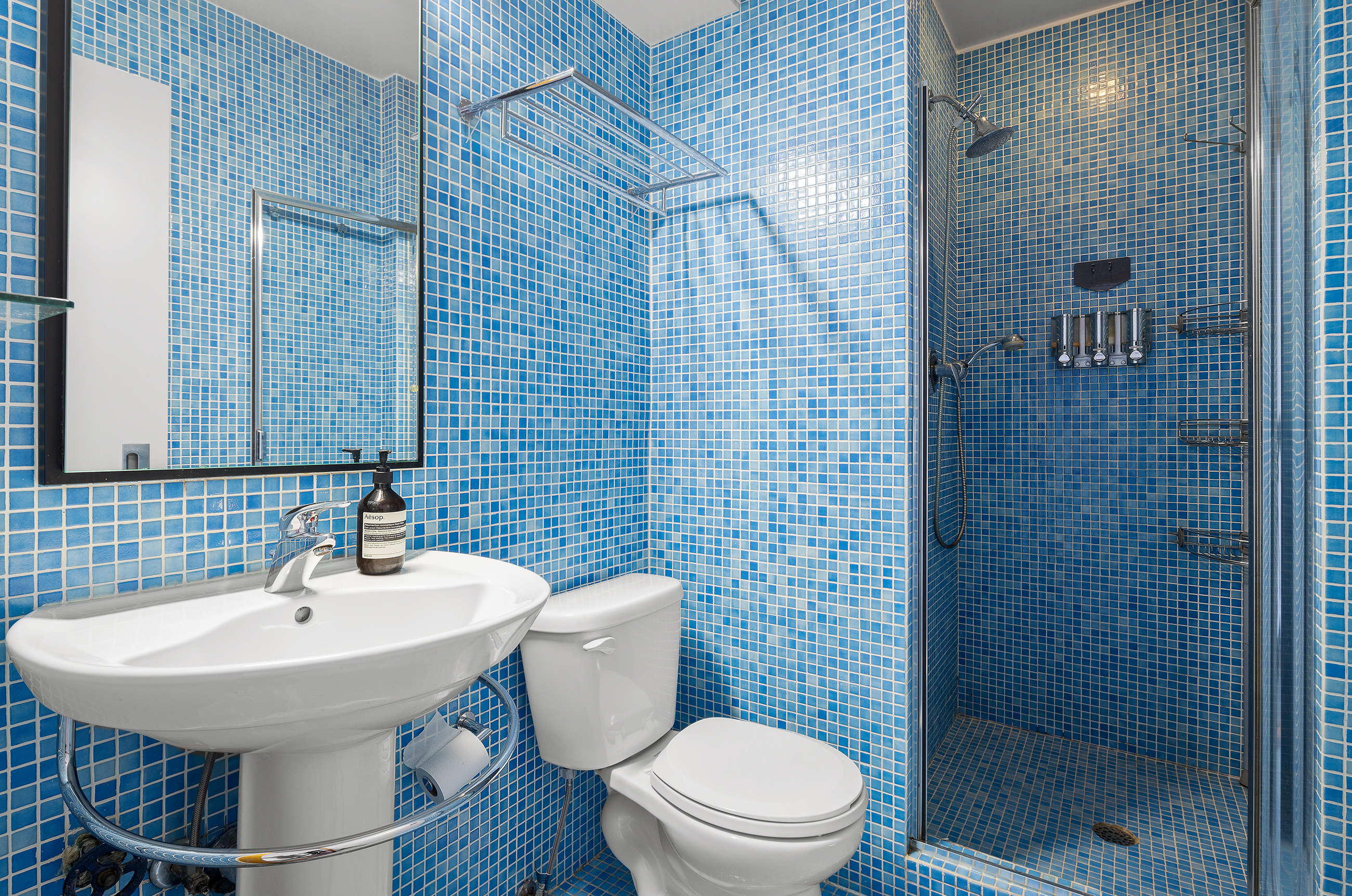 181 7th Avenue, Unit 11A Manhattan, NY 10011 - Photo 10 of 13 a bathroom with a sink toilet and shower