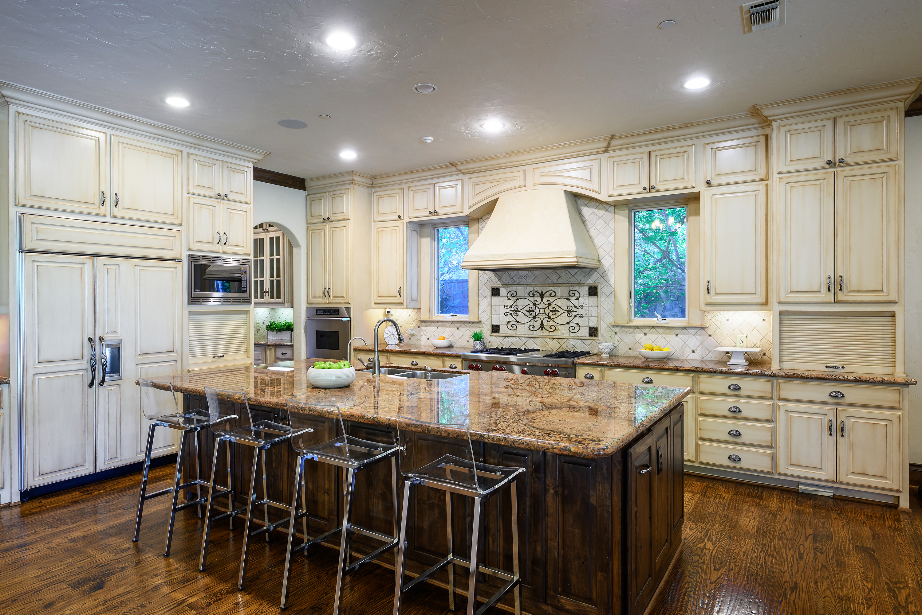 11503 West Ricks Circle Dallas, TX 75230 - Photo 15 of 39 a kitchen with stainless steel appliances granite countertop a table chairs sink refrigerator and cabinets