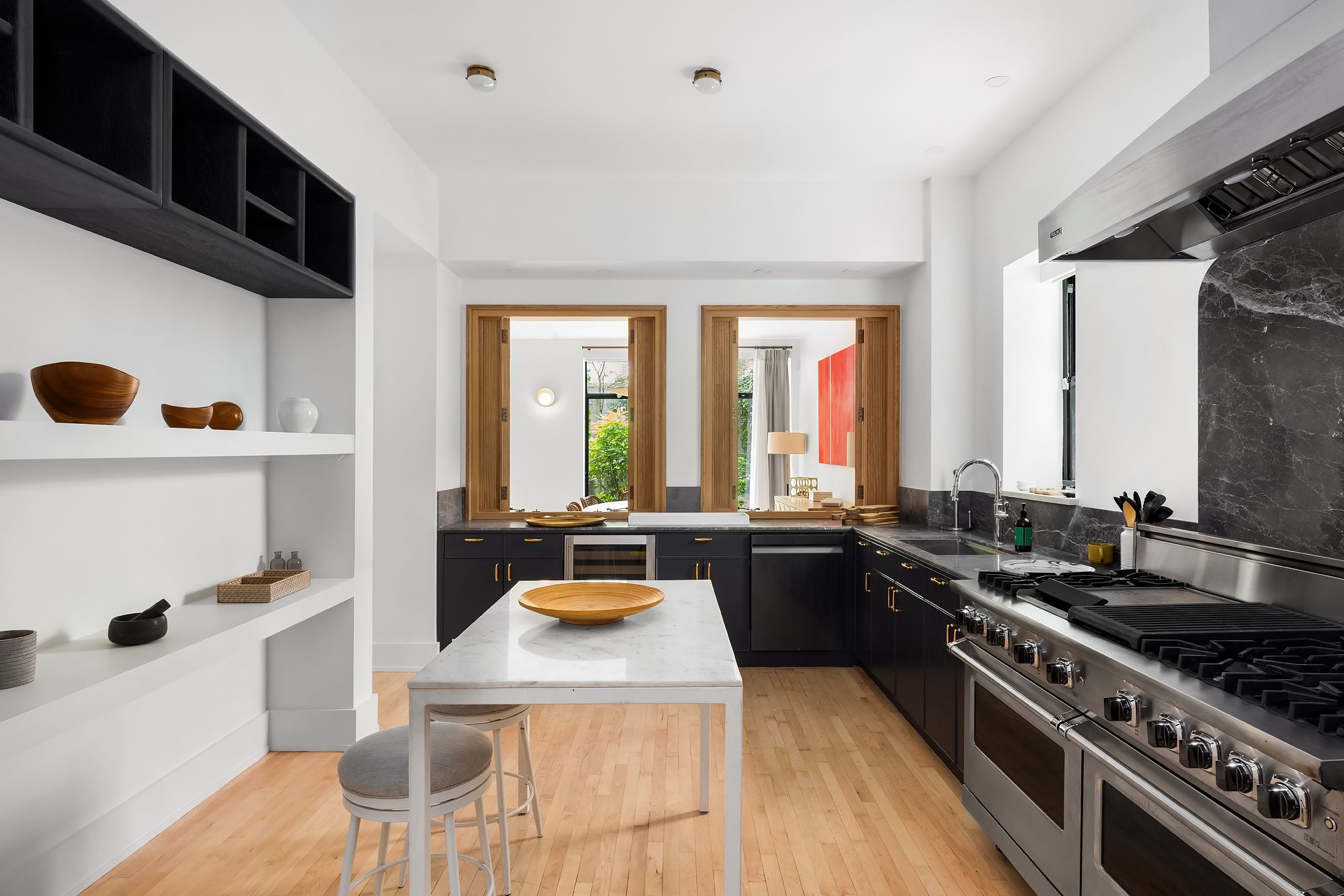 134 Charles Street Manhattan, NY 10014 - Photo 4 of 10 a kitchen with a stove a sink and a refrigerator