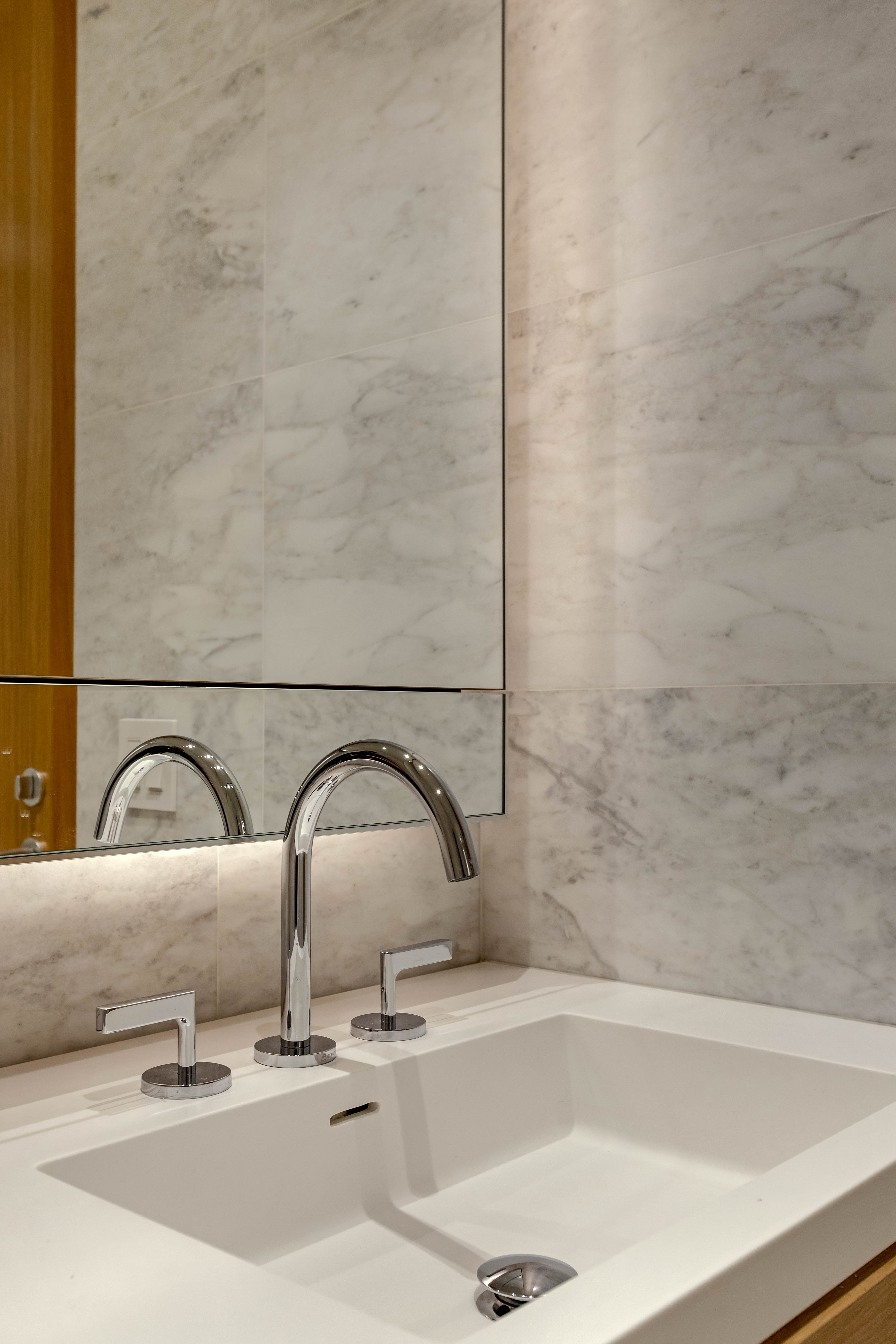565 Broome Street, Unit S7B Manhattan, NY 10013 - Photo 5 of 13 a bathroom with a sink and mirror