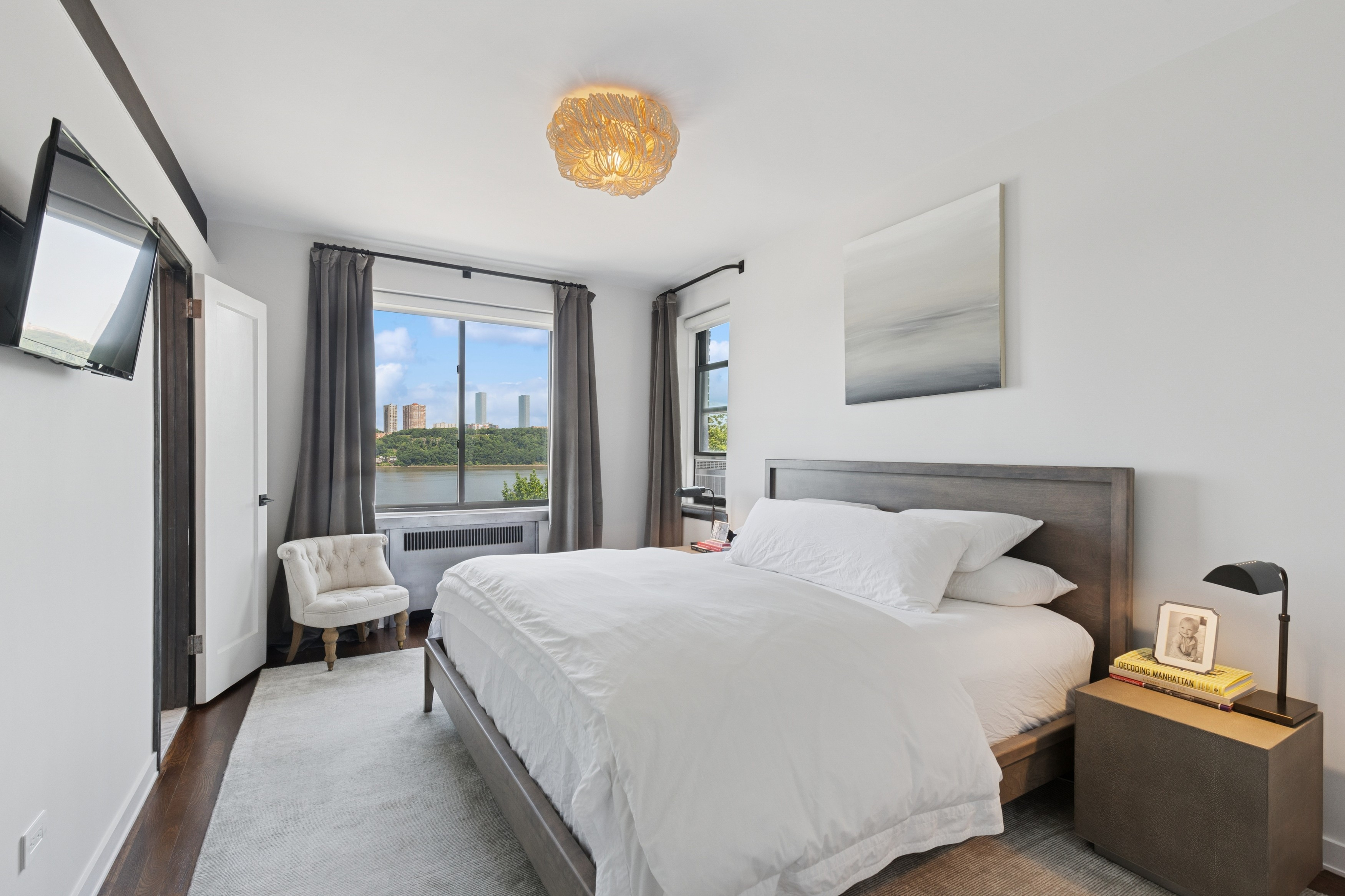 159-34 Riverside Drive West, Unit 5A Manhattan, NY 10032 - Photo 6 of 29 a bedroom with a bed a painting on the wall and a large window