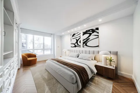 a bedroom with a bed couch and a large window