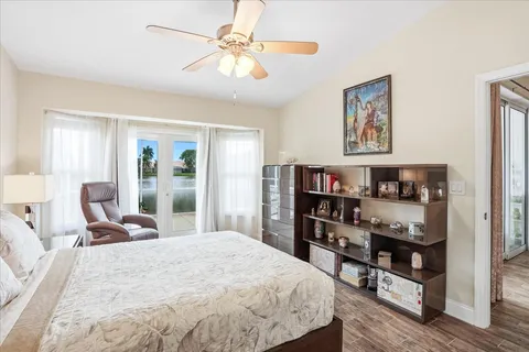 a bedroom with a bed a dresser and book shelf