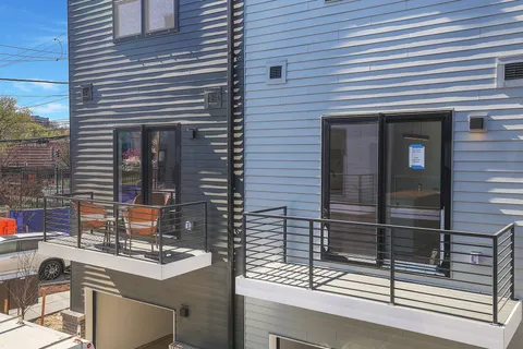 a view of a house with a table and chairs