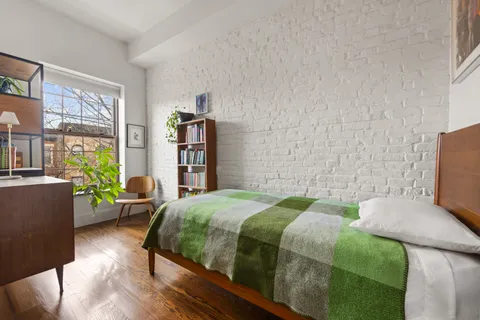 a bedroom with a bed and a couch