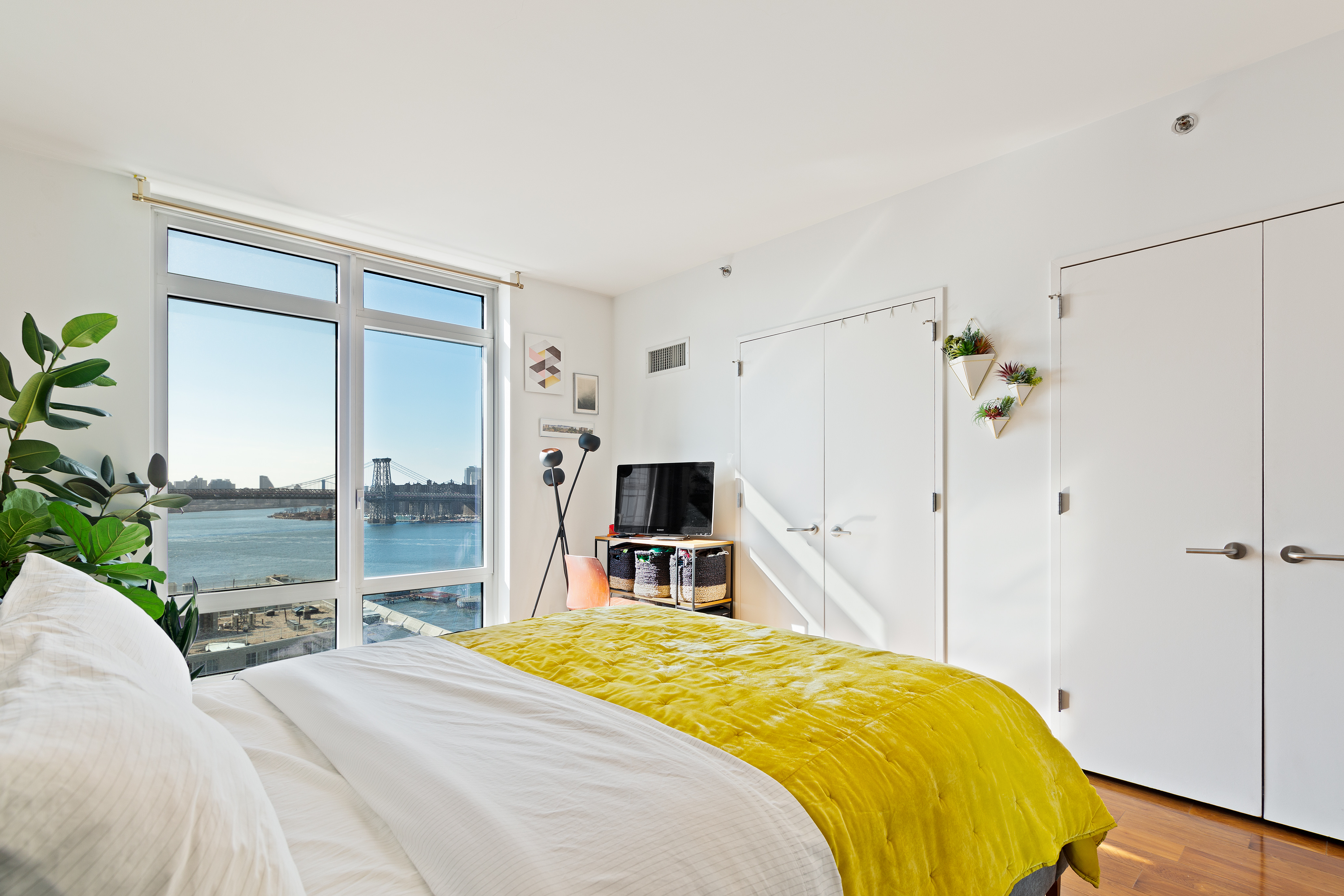 2 Northside Piers, Unit 20C Brooklyn, NY 11249 - Photo 5 of 12 a bedroom with a bed and a tv