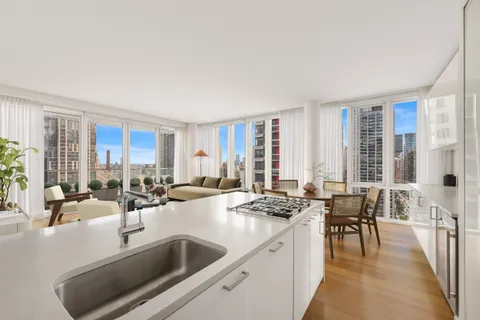 a kitchen with sink refrigerator and cabinets