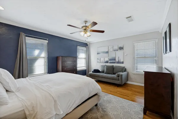 a bedroom with a bed couch and window