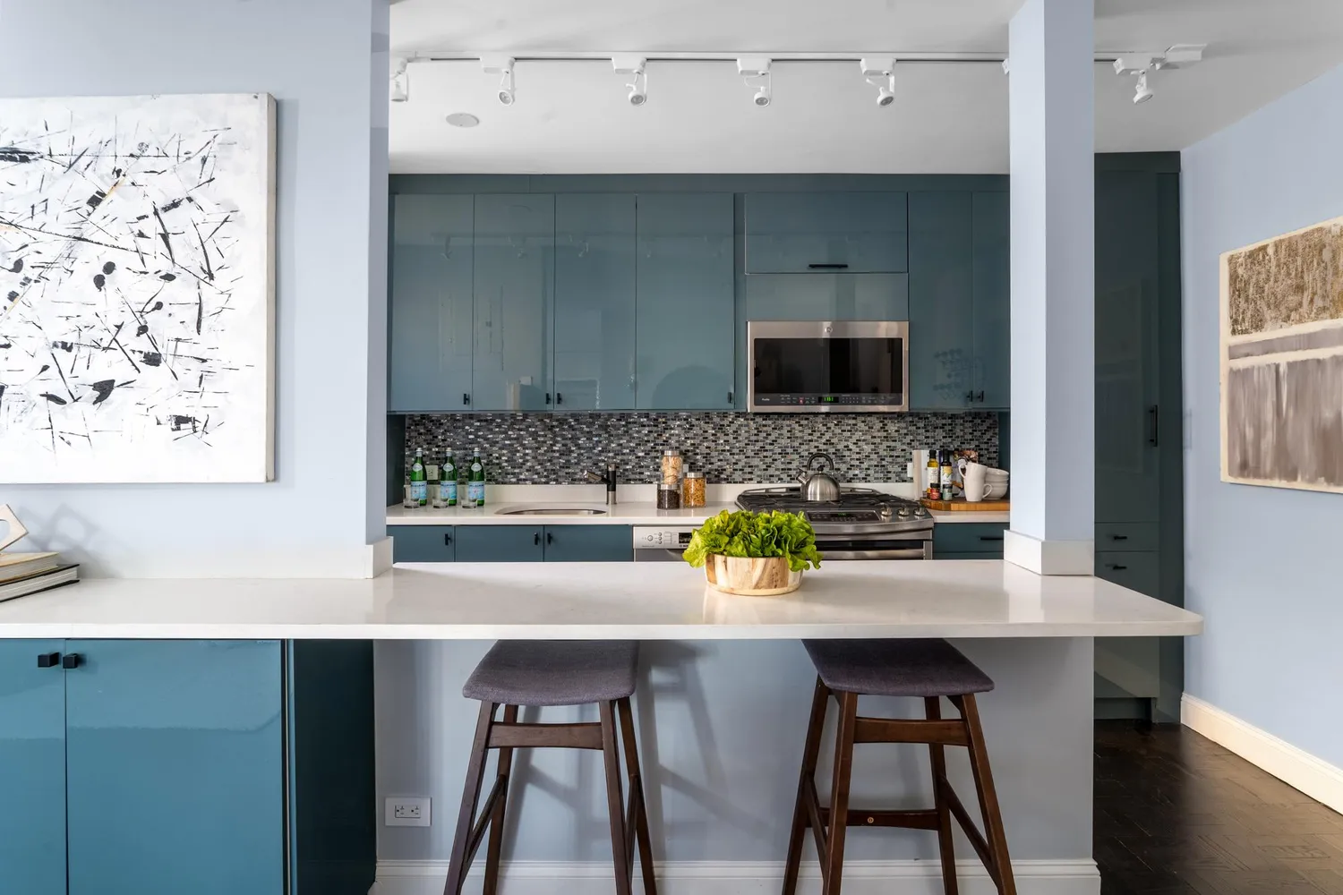 a kitchen with a sink cabinets and wooden floor