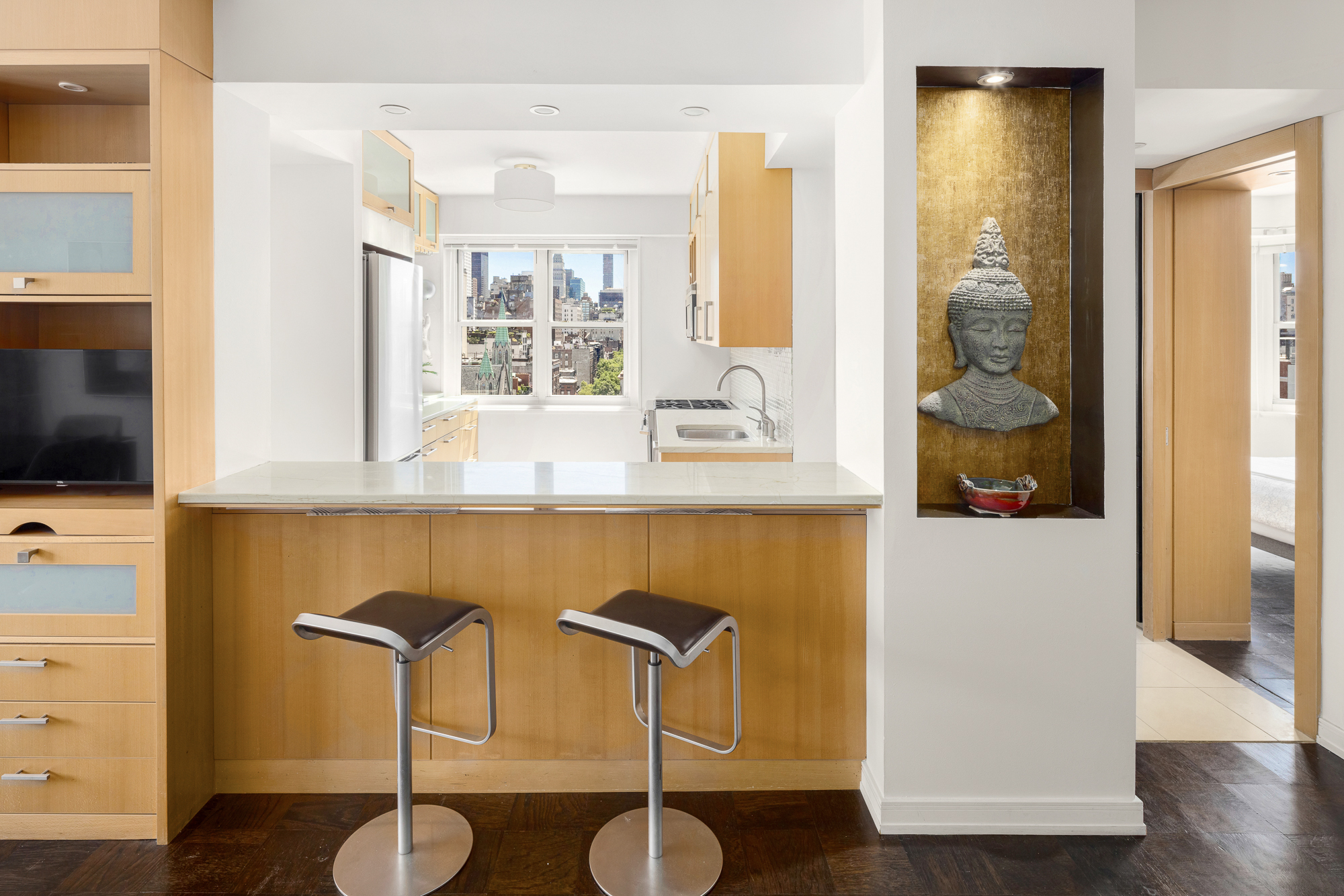 360 West 22nd Street, Unit 12L Manhattan, NY 10011 - Photo 6 of 21 a kitchen with a table and a chair