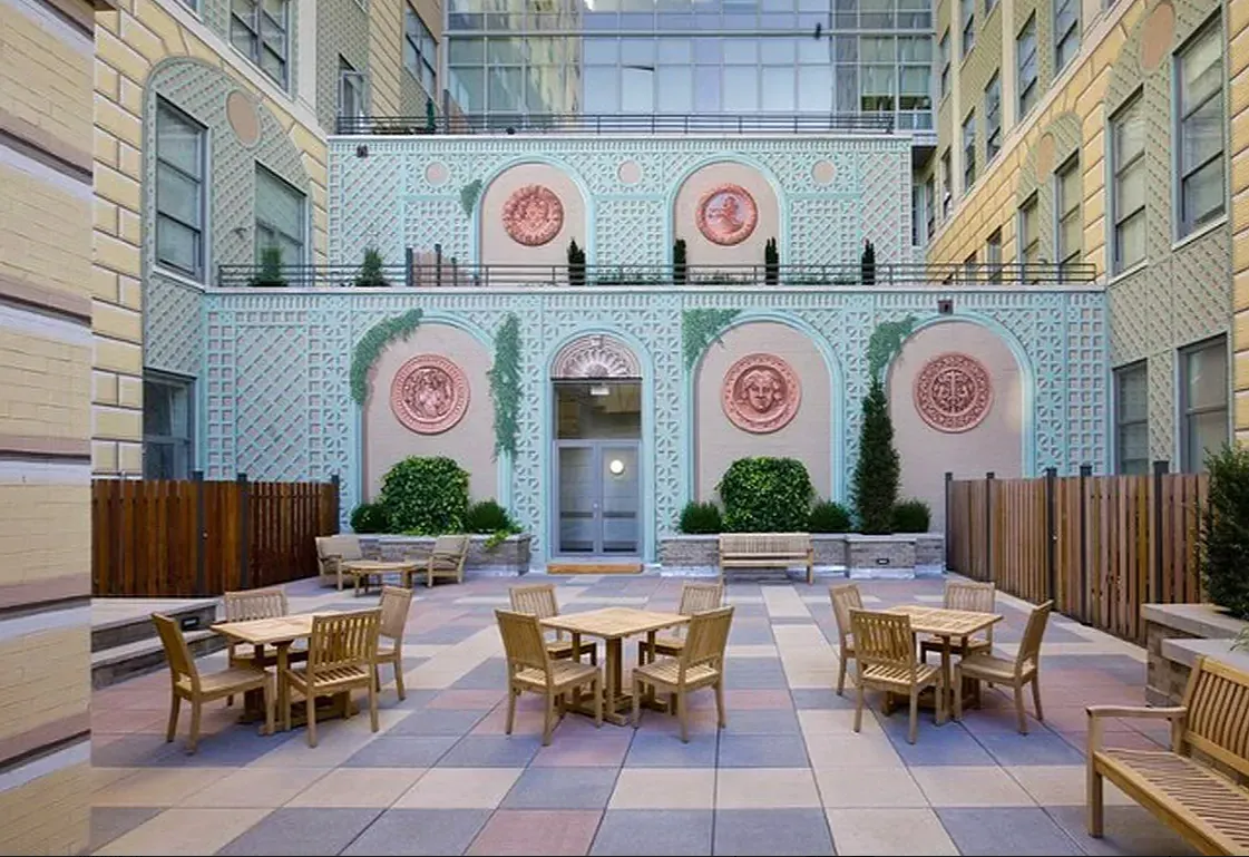 a group of table and chairs in a city street