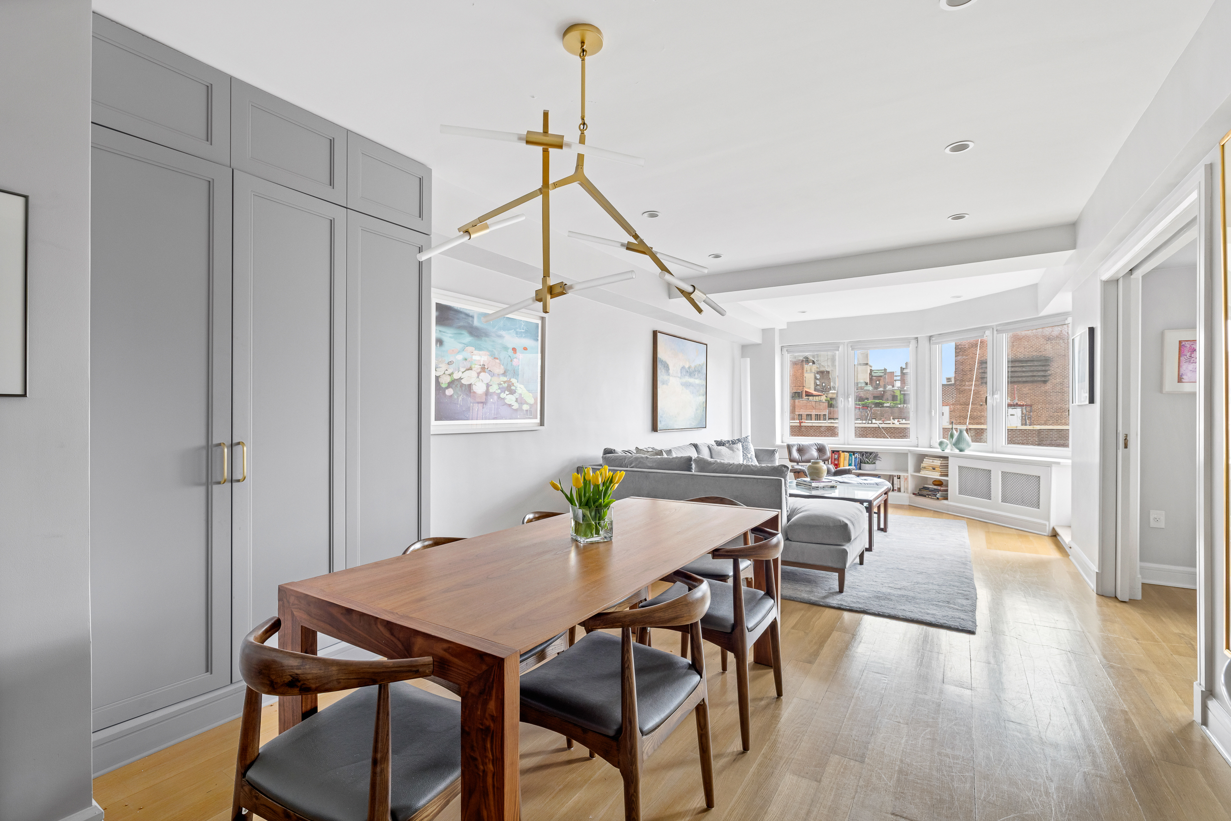 80 East End Avenue, Unit 17C Manhattan, NY 10028 - Photo 5 of 11 a view of a dining room with furniture window and wooden floor
