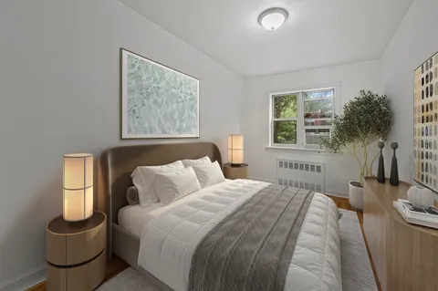 a bedroom with a bed and a painting on the wall