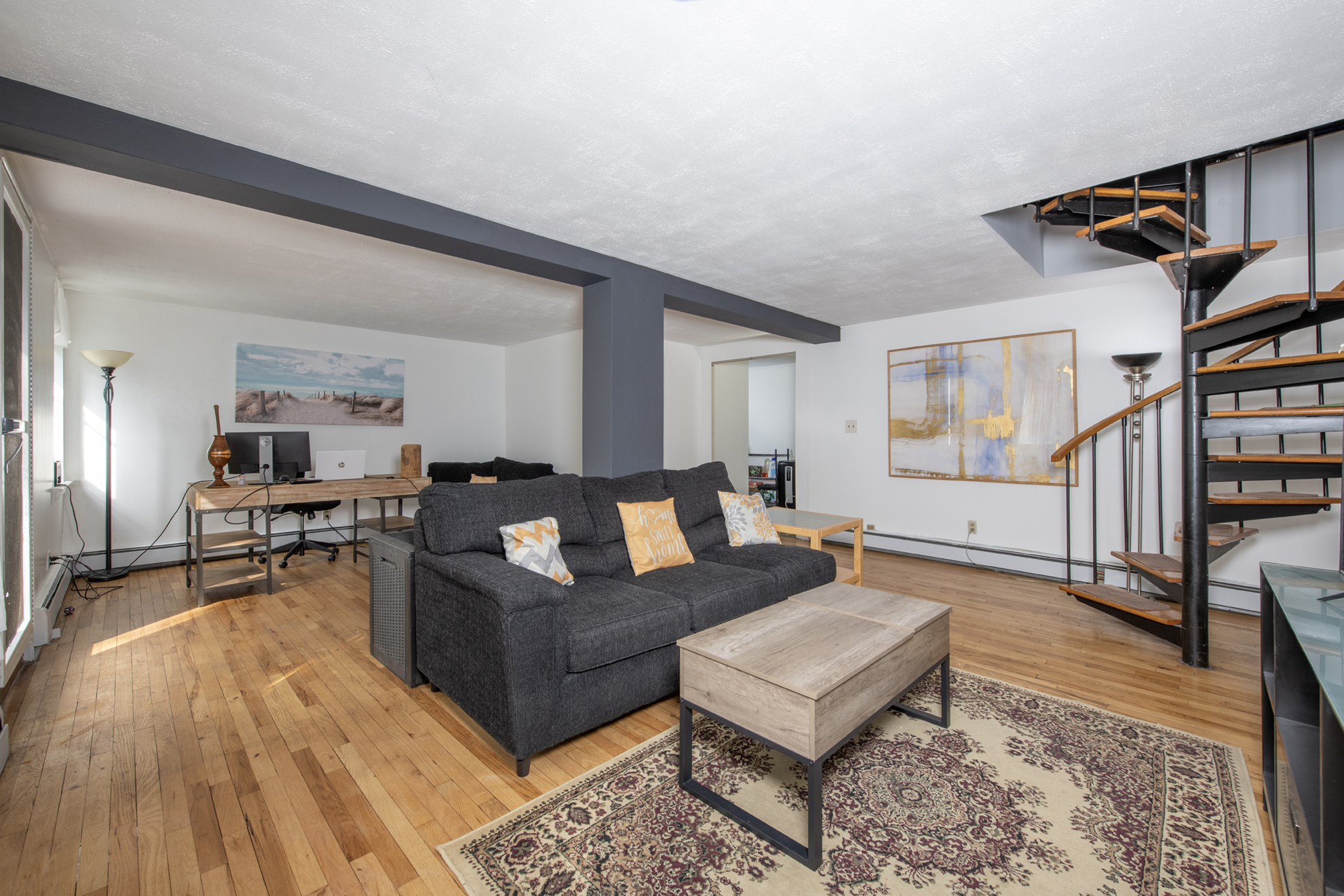352 West 117th Street, Unit 1E Manhattan, NY 10026 - Photo 4 of 13 a living room with furniture and a wooden floor
