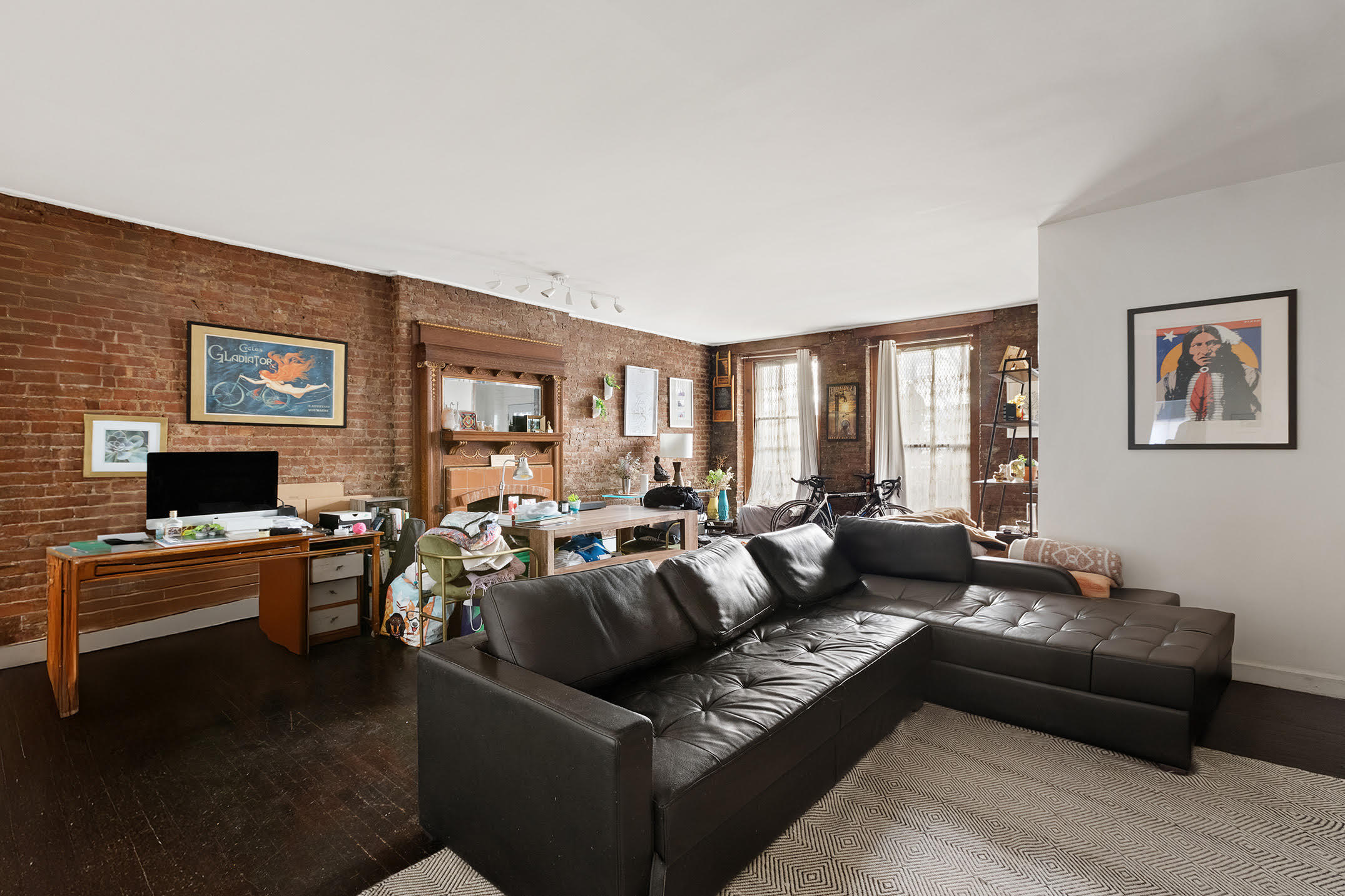 138 West 73rd Street Manhattan, NY 10023 - Photo 30 of 35 a living room with furniture a large window and a flat screen tv