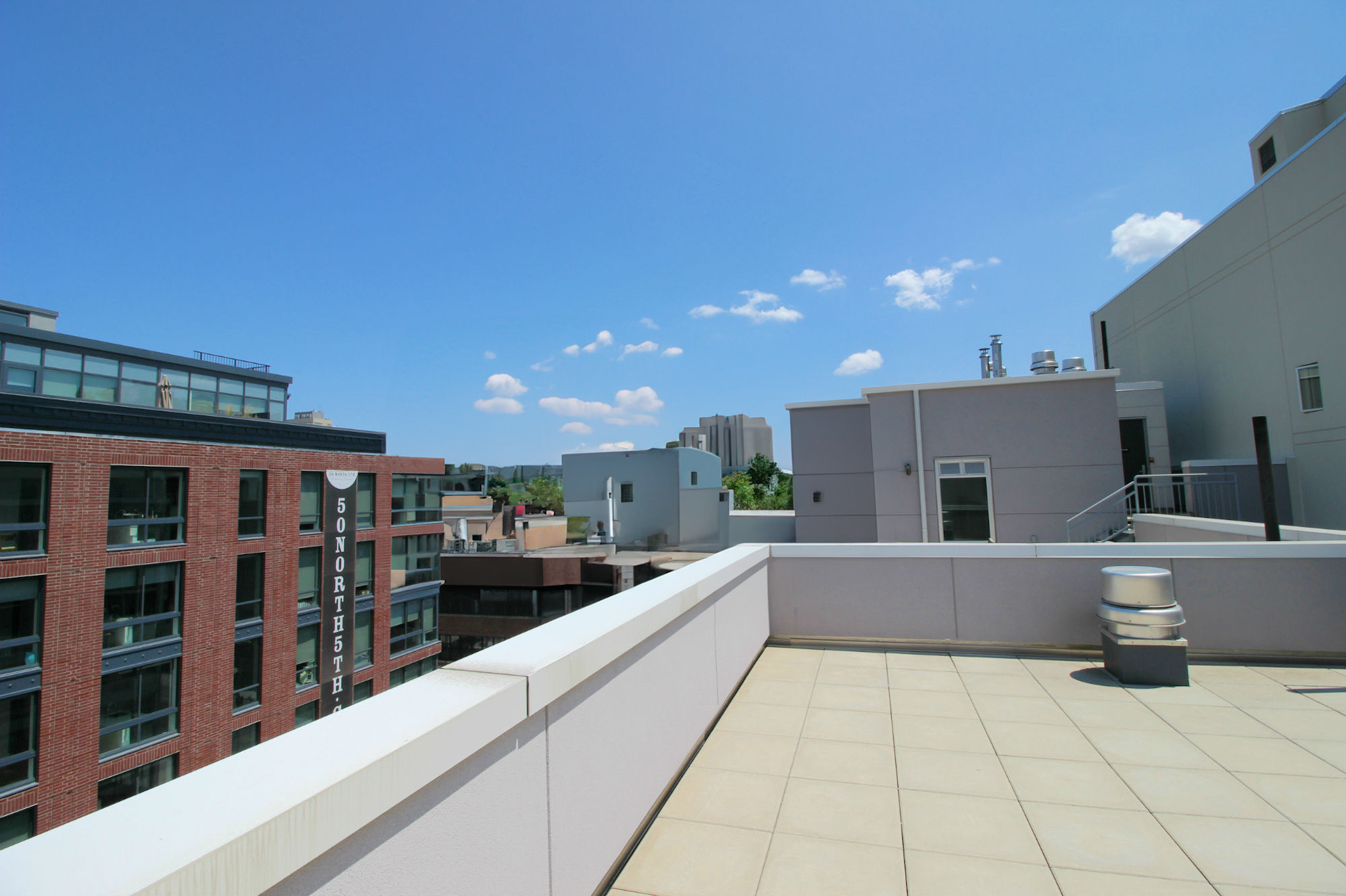 224 Wythe Avenue, Unit 68E Brooklyn, NY 11249 - Photo 8 of 10 a large white kitchen with a large window and refrigerator