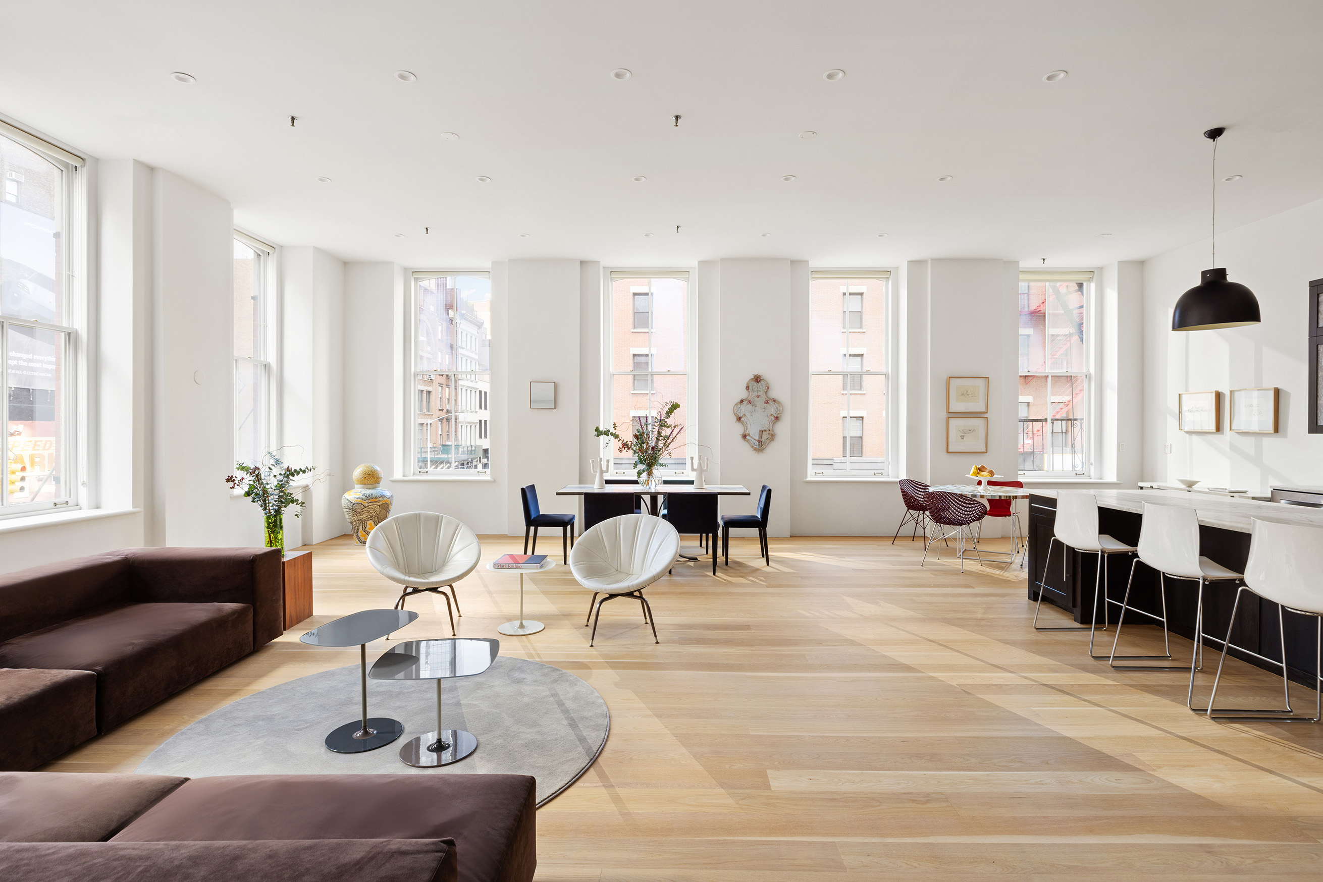 60 Warren Street, Unit 2 Manhattan, NY 10007 - Photo 2 of 16 a living room with furniture and large windows