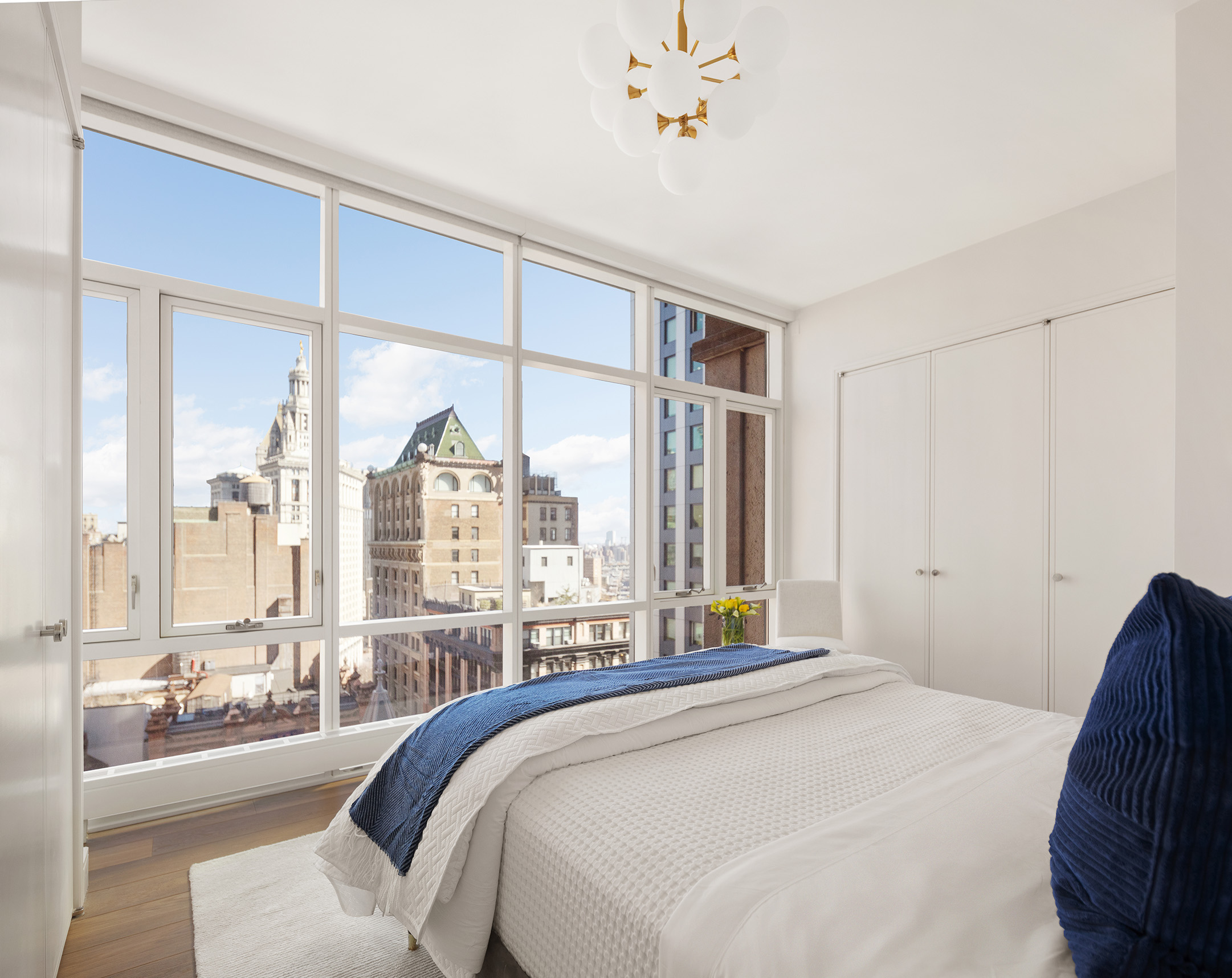 5 Beekman Street, Unit 21B Manhattan, NY 10038 - Photo 8 of 23 a bedroom with a large bed and a large window