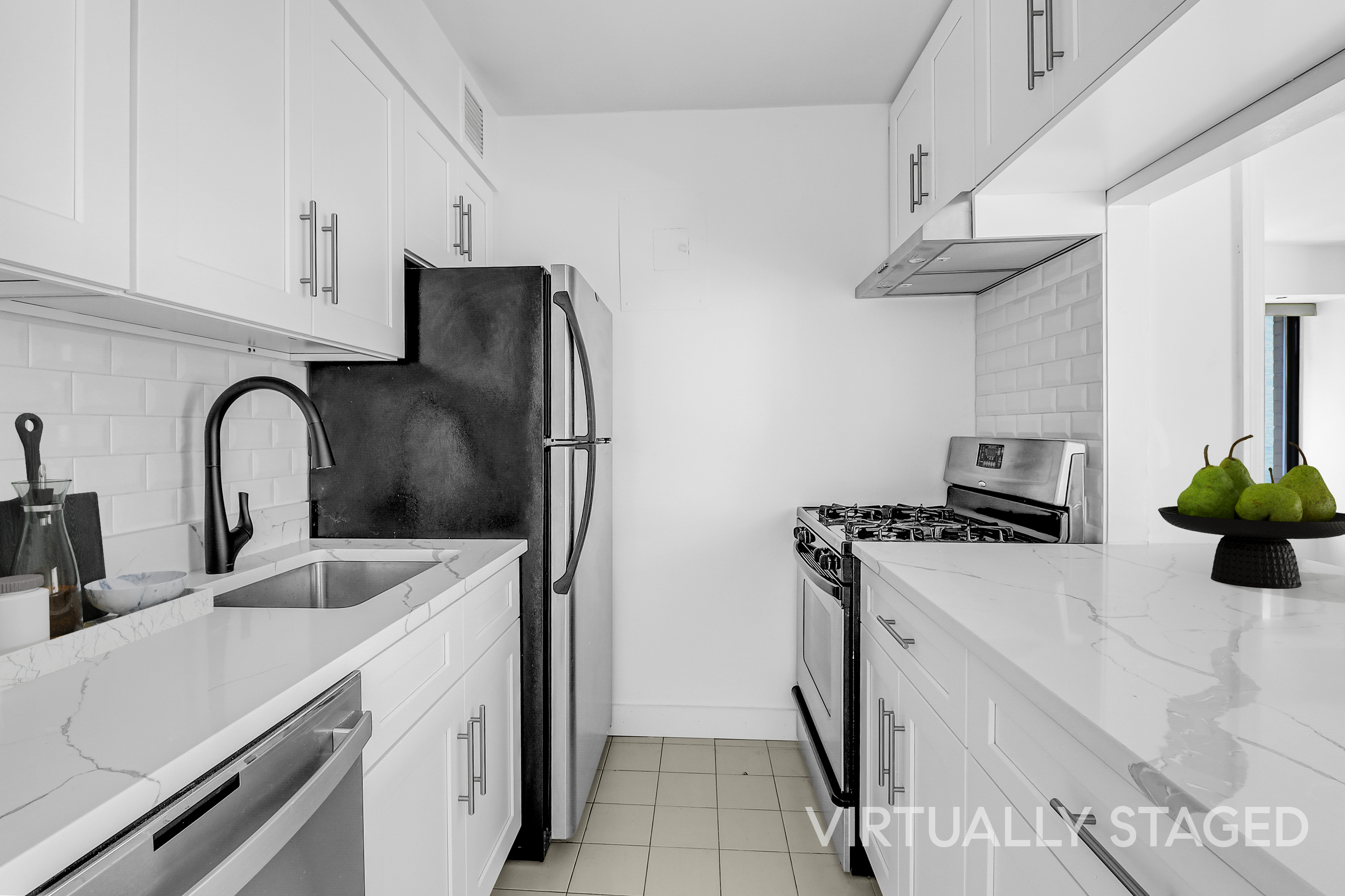 400 East 70th Street, Unit 1008 Manhattan, NY 10021 - Photo 5 of 15 a kitchen with stainless steel appliances a sink a stove and a refrigerator