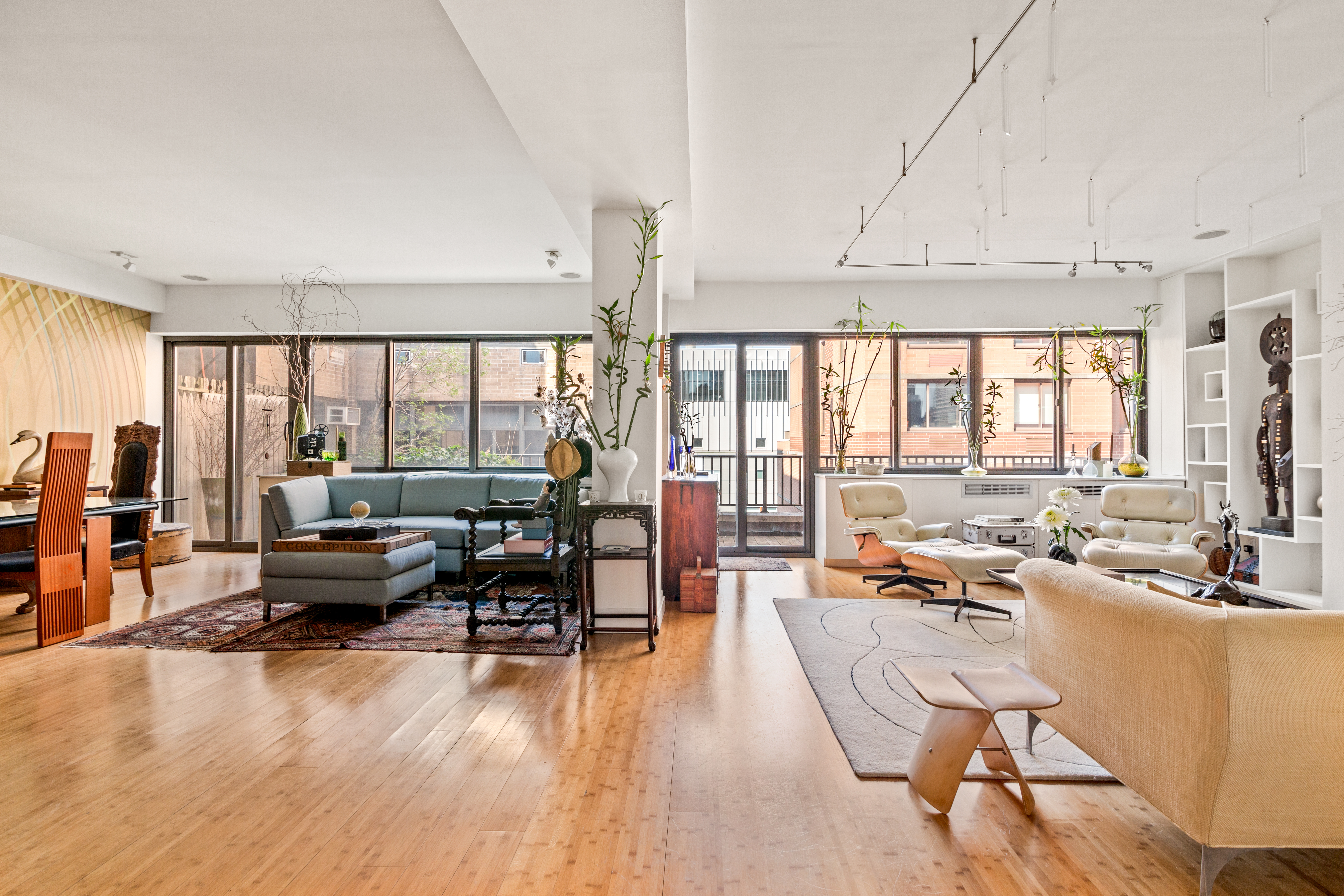 529 West 42nd Street, Unit 7A Manhattan, NY 10036 - Photo 2 of 18 a living room with furniture and large windows