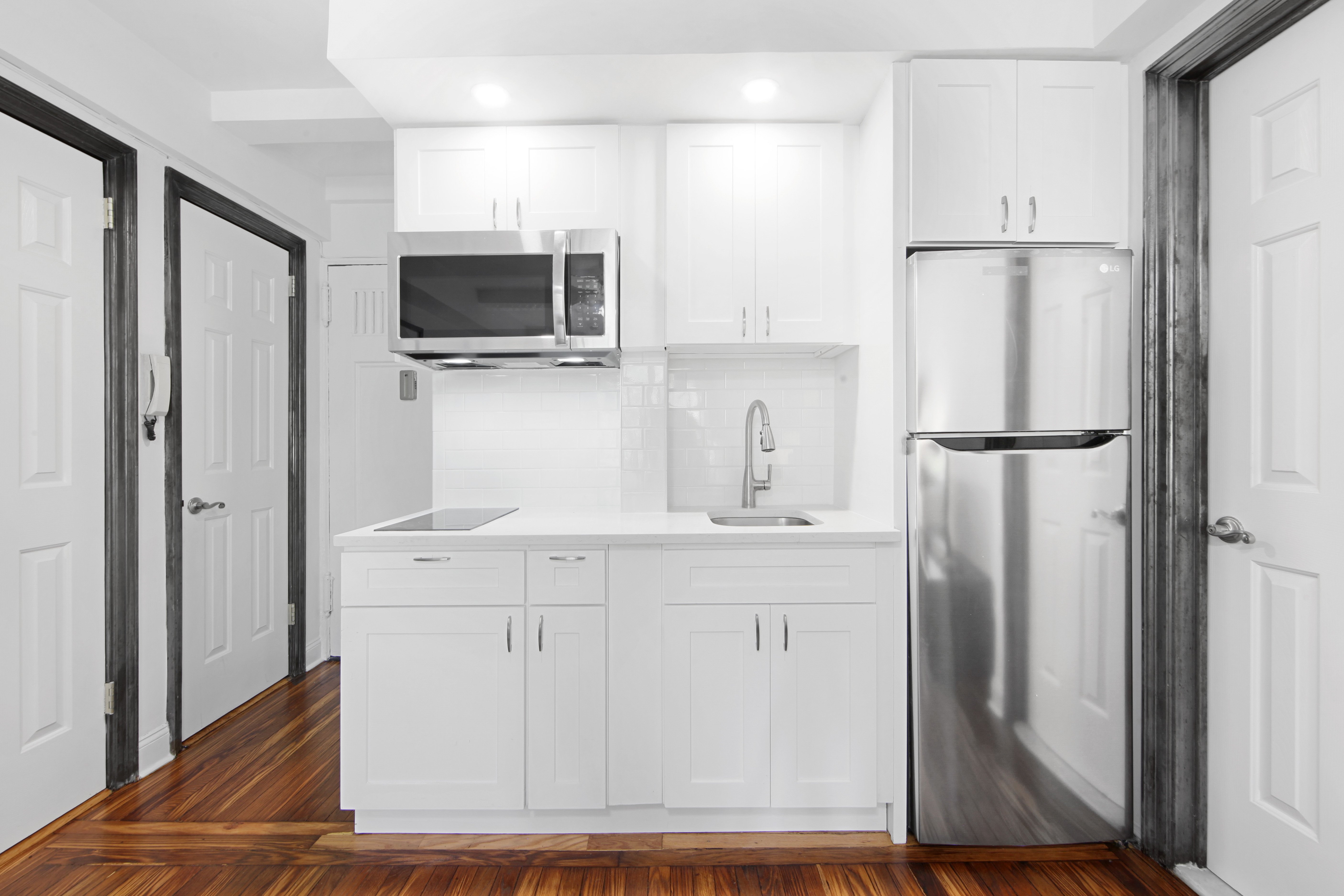 25 Tudor City Place, Unit 508 Manhattan, NY 10017 - Photo 6 of 17 a kitchen with stainless steel appliances a refrigerator and cabinets