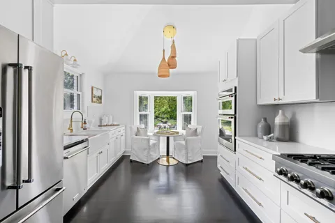 a view of a very nice looking living room with a large window and chandelier