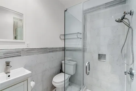 a bathroom with a toilet sink and shower