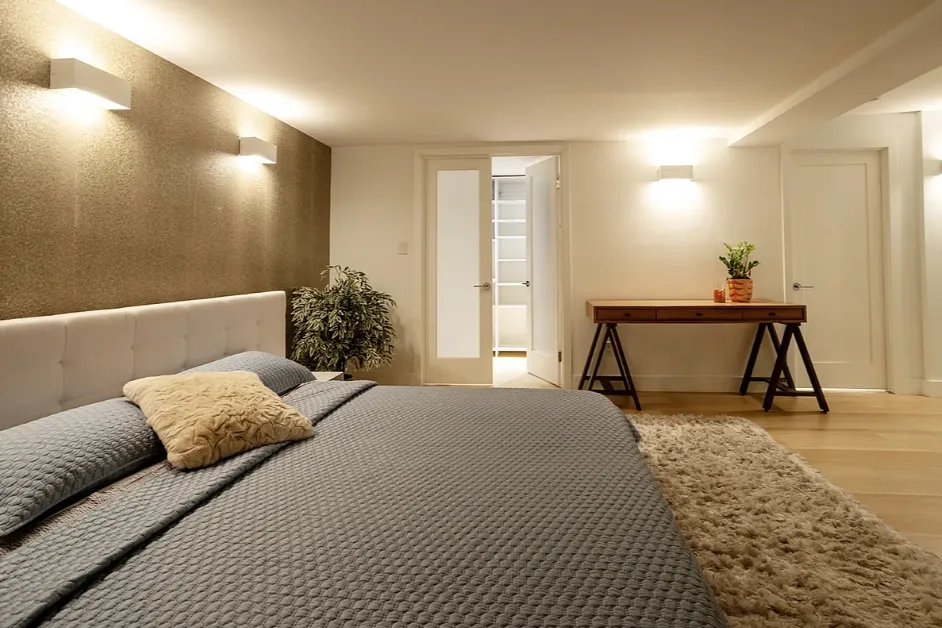 a bedroom with a bed and a couch