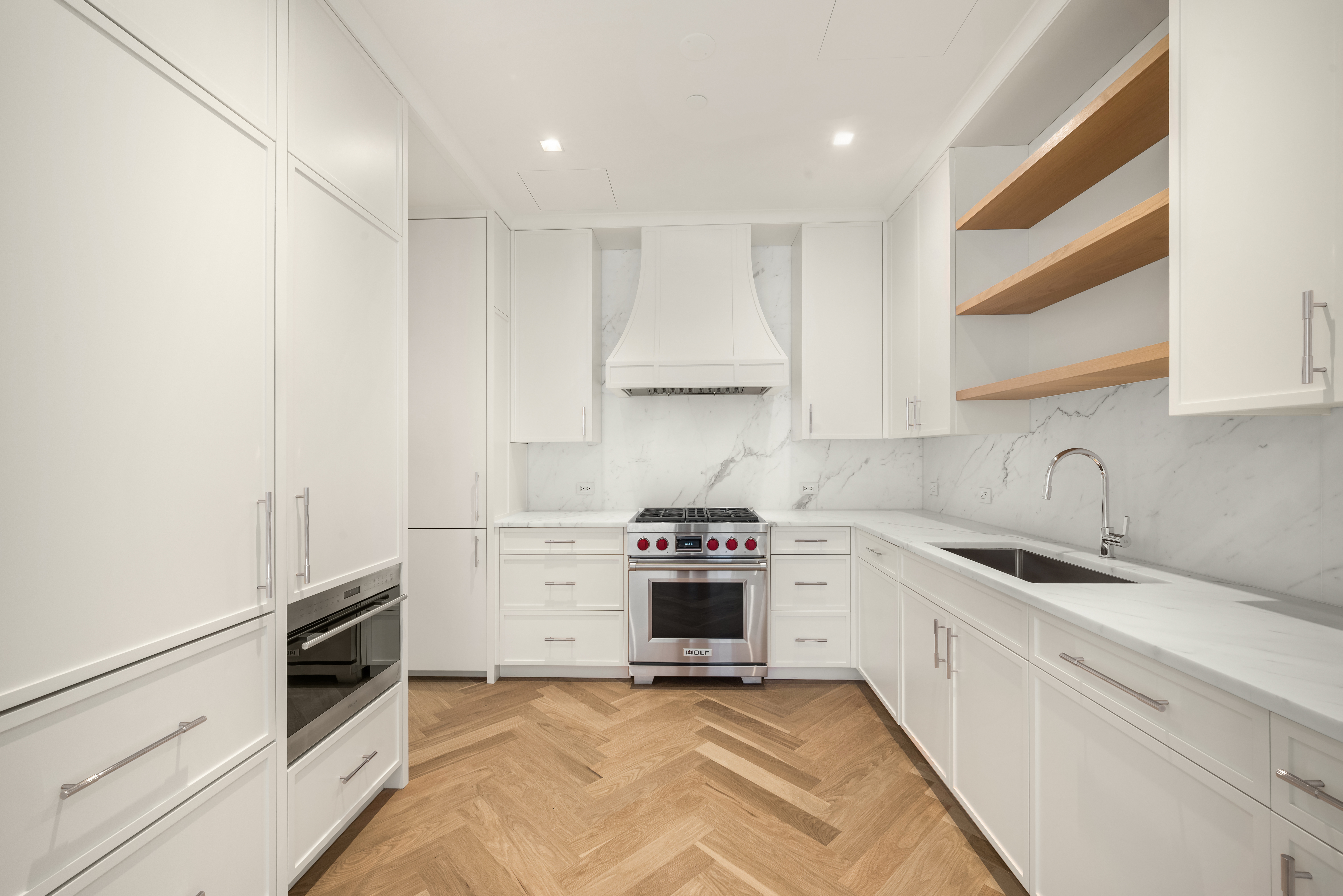 200 East 75th Street, Unit 6C Manhattan, NY 10021 - Photo 1 of 11 a kitchen with stainless steel appliances granite countertop a stove and a sink