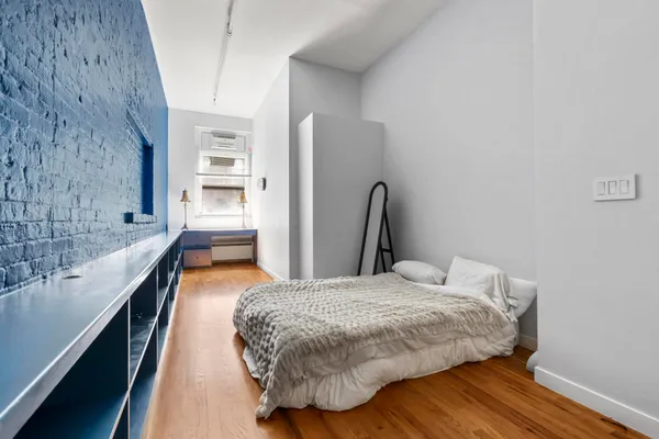 a bedroom with a bed and a window