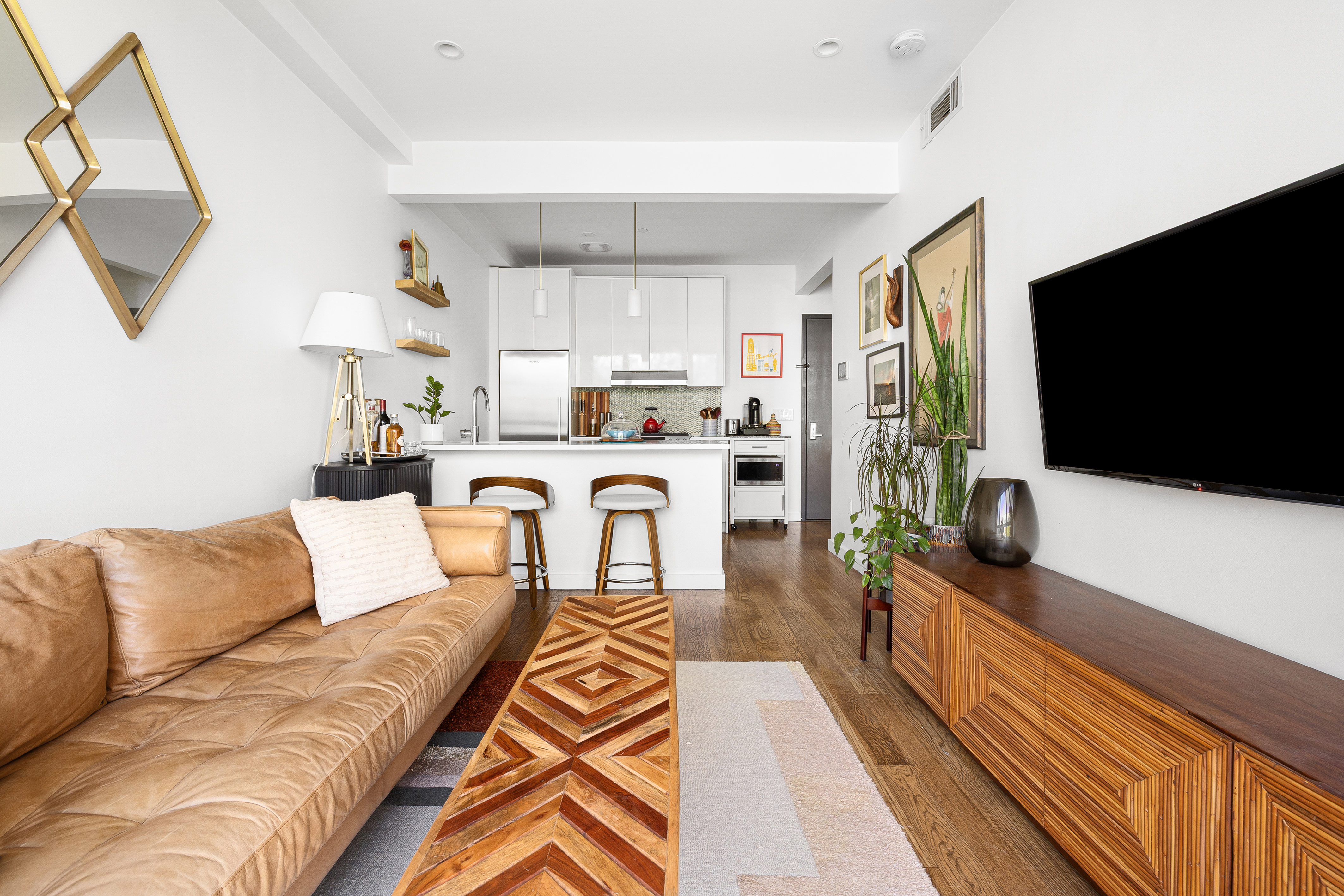 307 Cooper Street, Unit 3B Brooklyn, NY 11237 - Photo 4 of 10 a living room with furniture and a flat screen tv