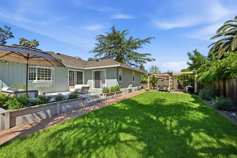 a front view of house with yard and outdoor seating