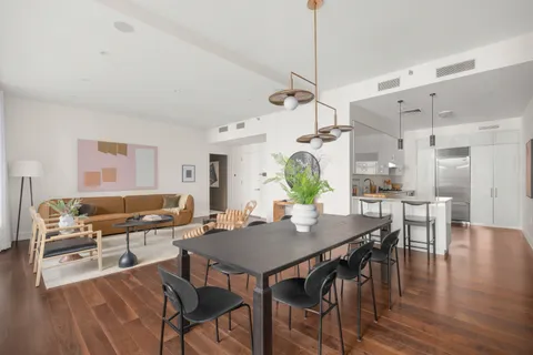 a view of a dining room with furniture window and wooden floor