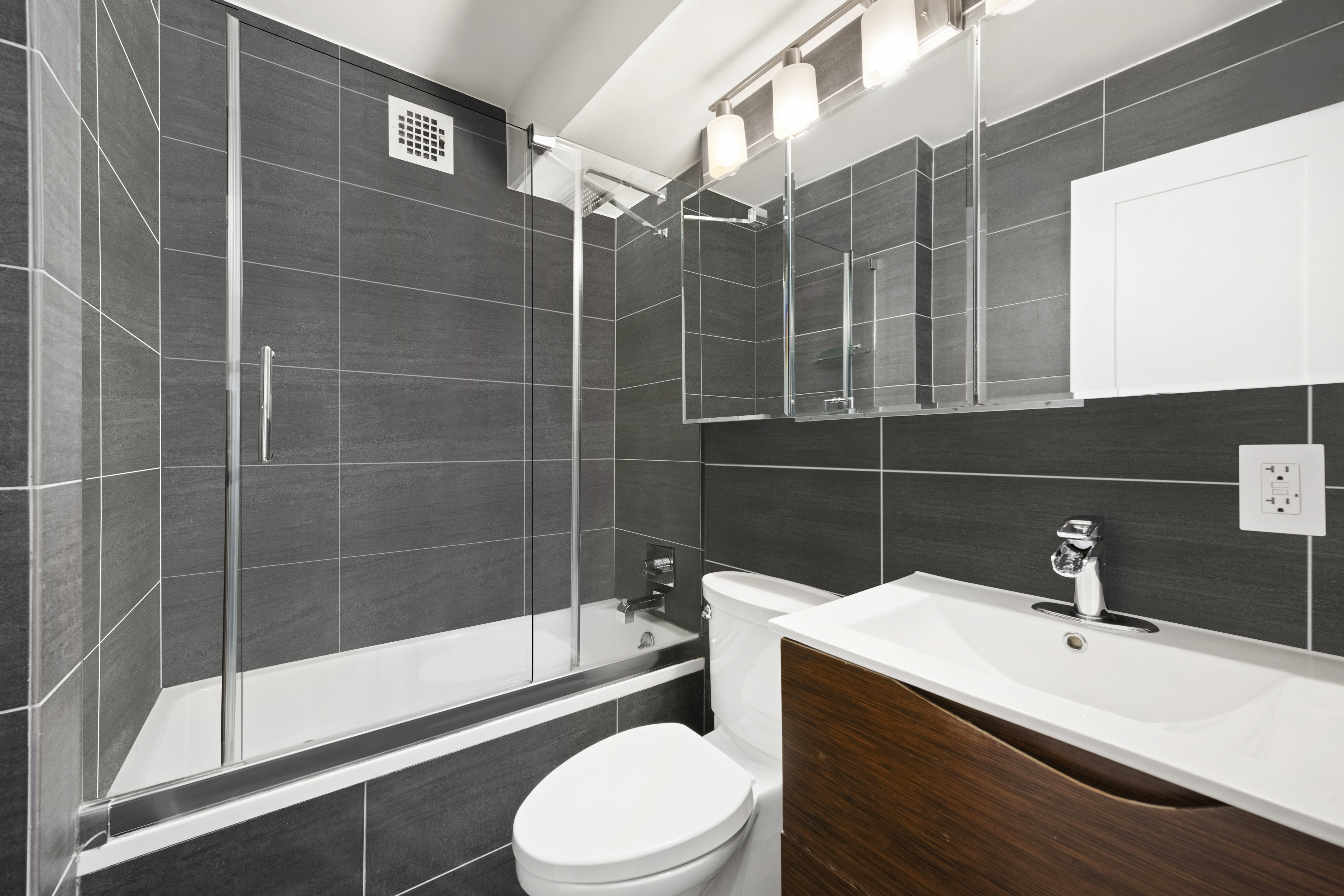 240 East 76th Street, Unit 2E Manhattan, NY 10021 - Photo 5 of 11 a bathroom with a sink toilet and shower