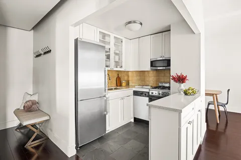 a kitchen with stainless steel appliances a stove refrigerator sink and microwave